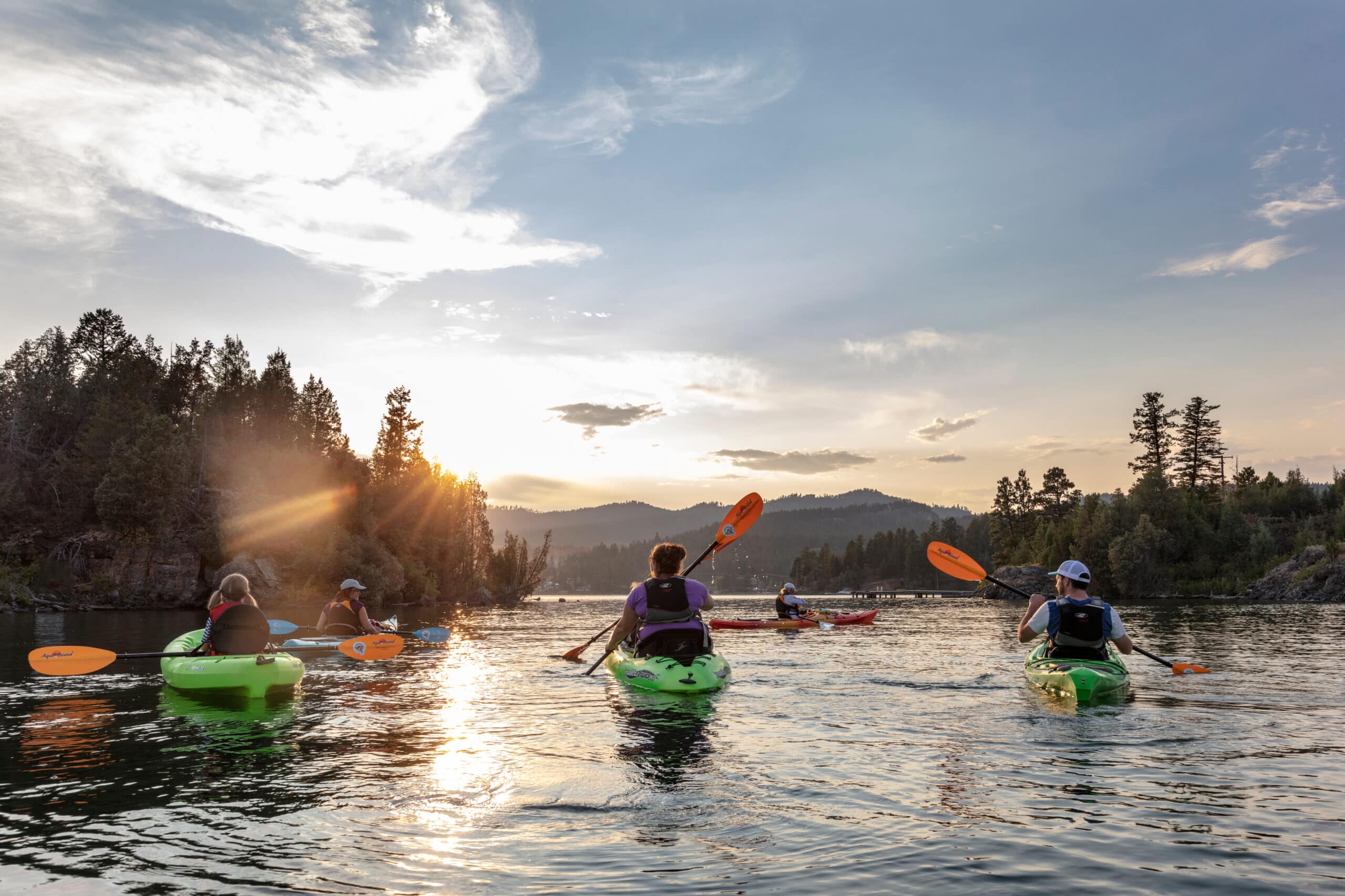 Family paddling to Wild Horse Island on Flathead Lake for a guided kayak tour with chances to spot bighorn sheep and wild horses in Montana.