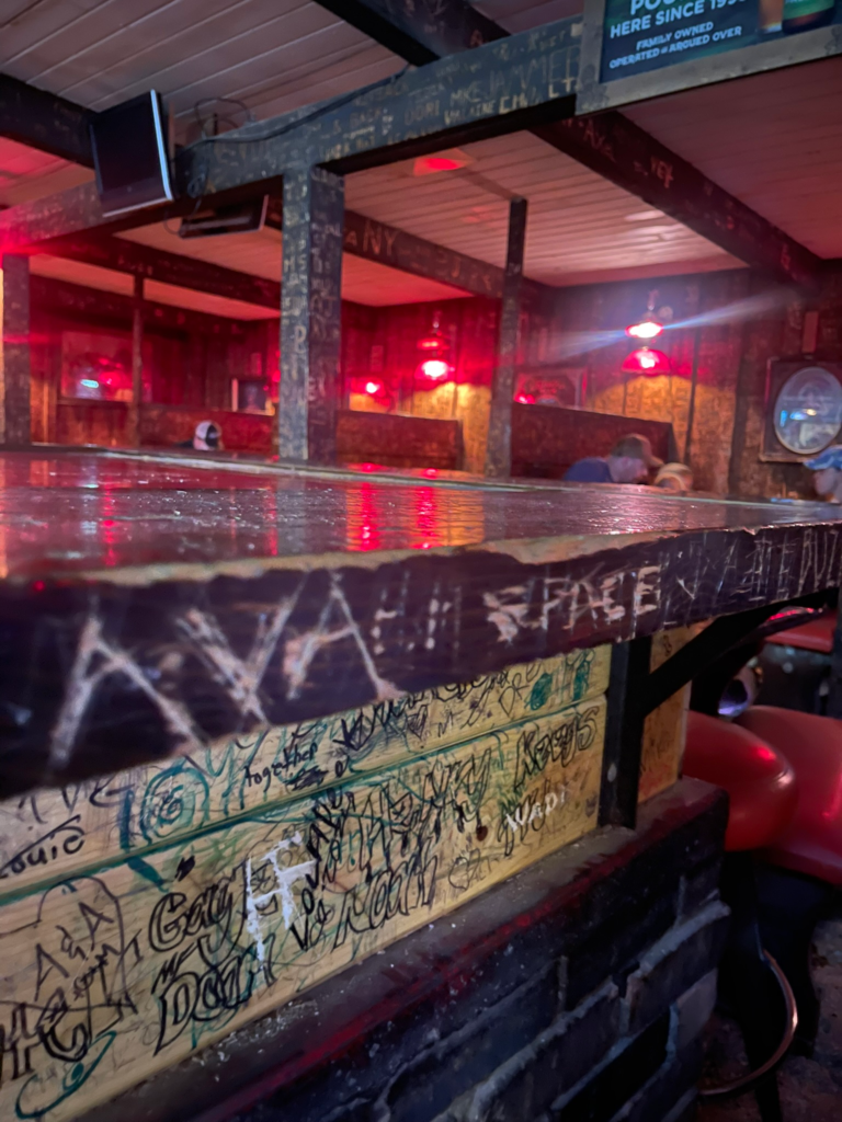 Names Ava and Price carved into the table and walls at Moose's Saloon and Pizza in Kalispell, MT