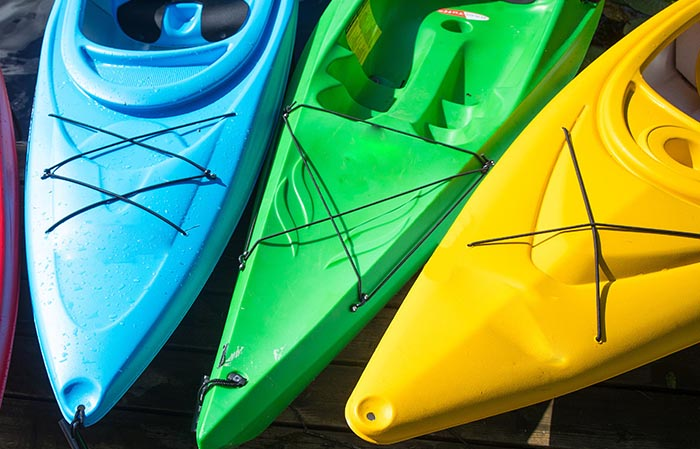 Colorful set of 3 kayaks available for rent at Whitefish Lake or Flathead Lake with Tour Glacier