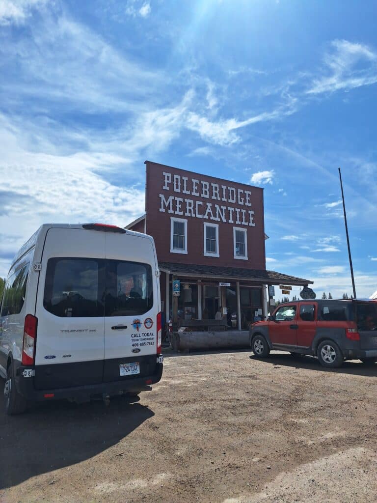 Tour Glacier Shuttle van parked in front of the Polebridge Mercantile